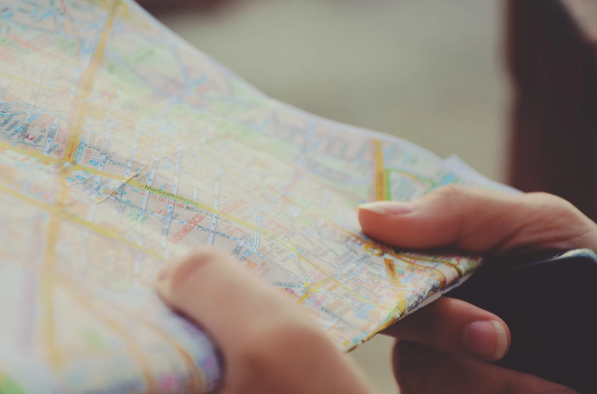 A person using a paper street map to find their way