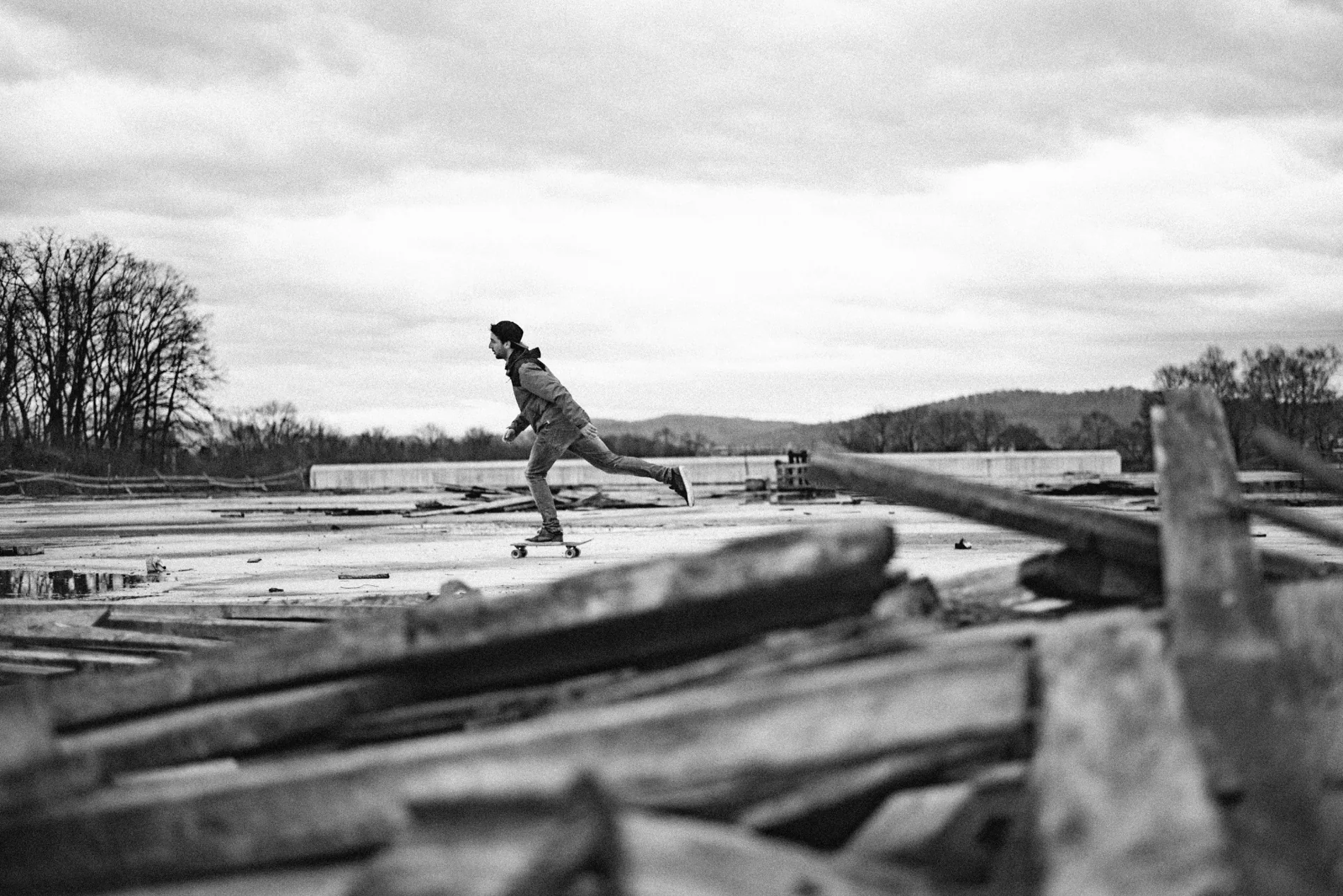 A skateboarder crossing an open concrete space